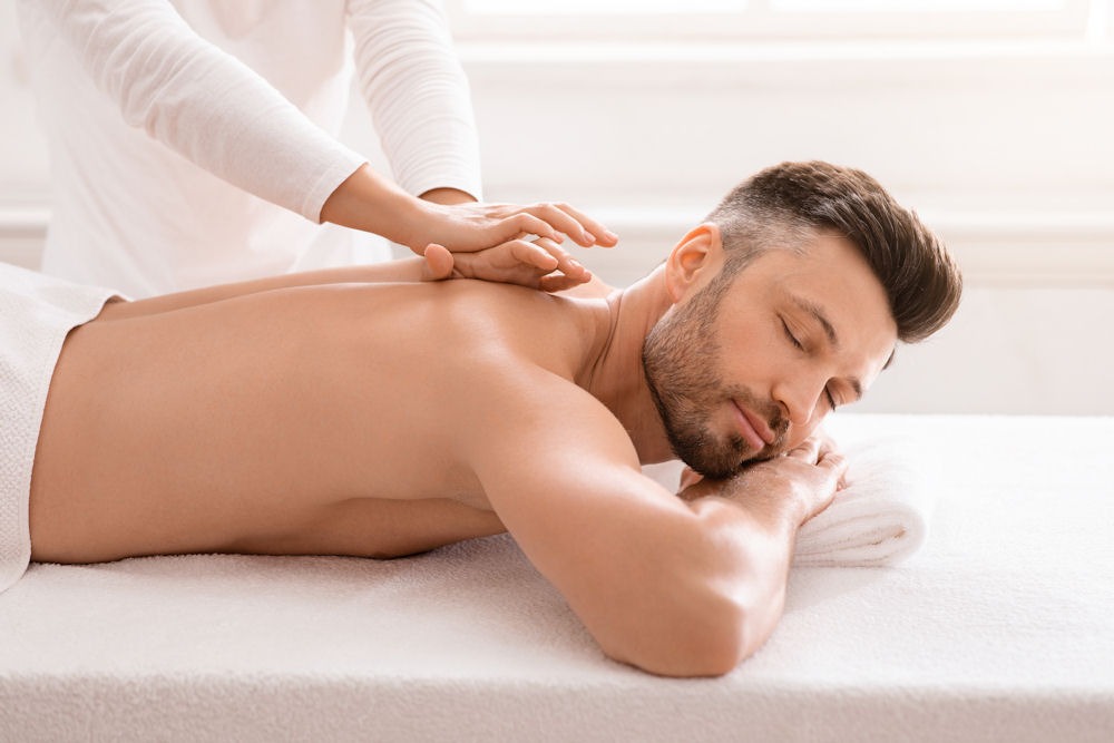 Man receiving a relaxing massage as part of mental health therapy