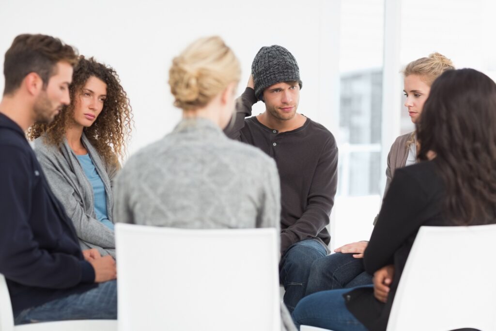 a group of patients sitting in circle during therapy