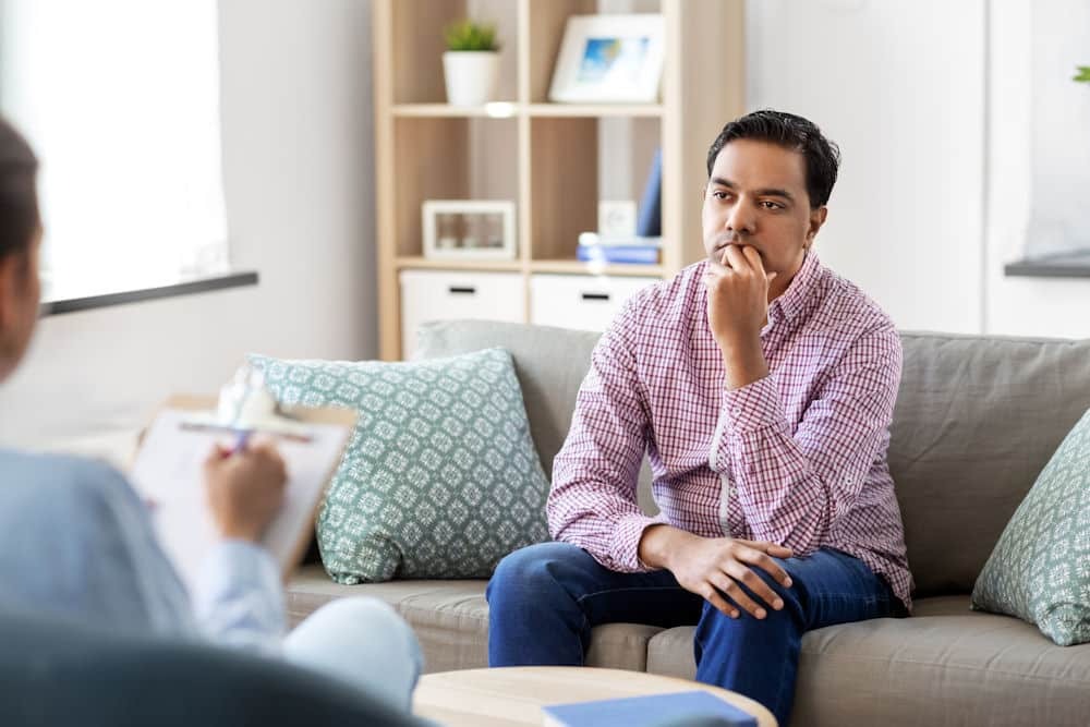 a man suffering from trauma attending mental health therapy